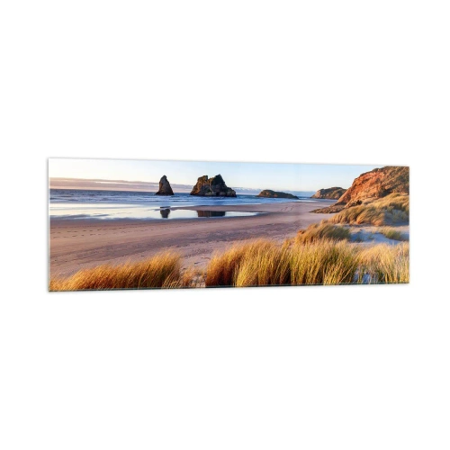 Obraz na szkle - Malownicza plaża z widokiem na skały i morze o zachodzie słońca - 160x50cm - Dla poszukiwaczy spokoju - Nowoczesna dekoracja ścienna do salonu i sypialni ARTTOR