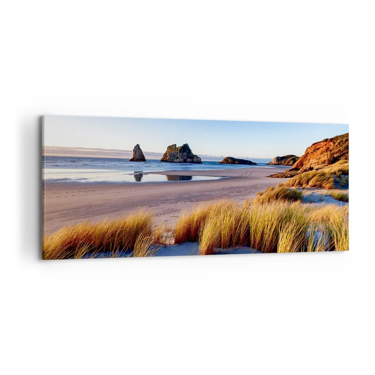 Obraz na płótnie - Malownicza plaża z widokiem na skały i morze o zachodzie słońca - 120x50cm - Dla poszukiwaczy spokoju - Nowoczesna dekoracja ścienna do salonu i sypialni ARTTOR