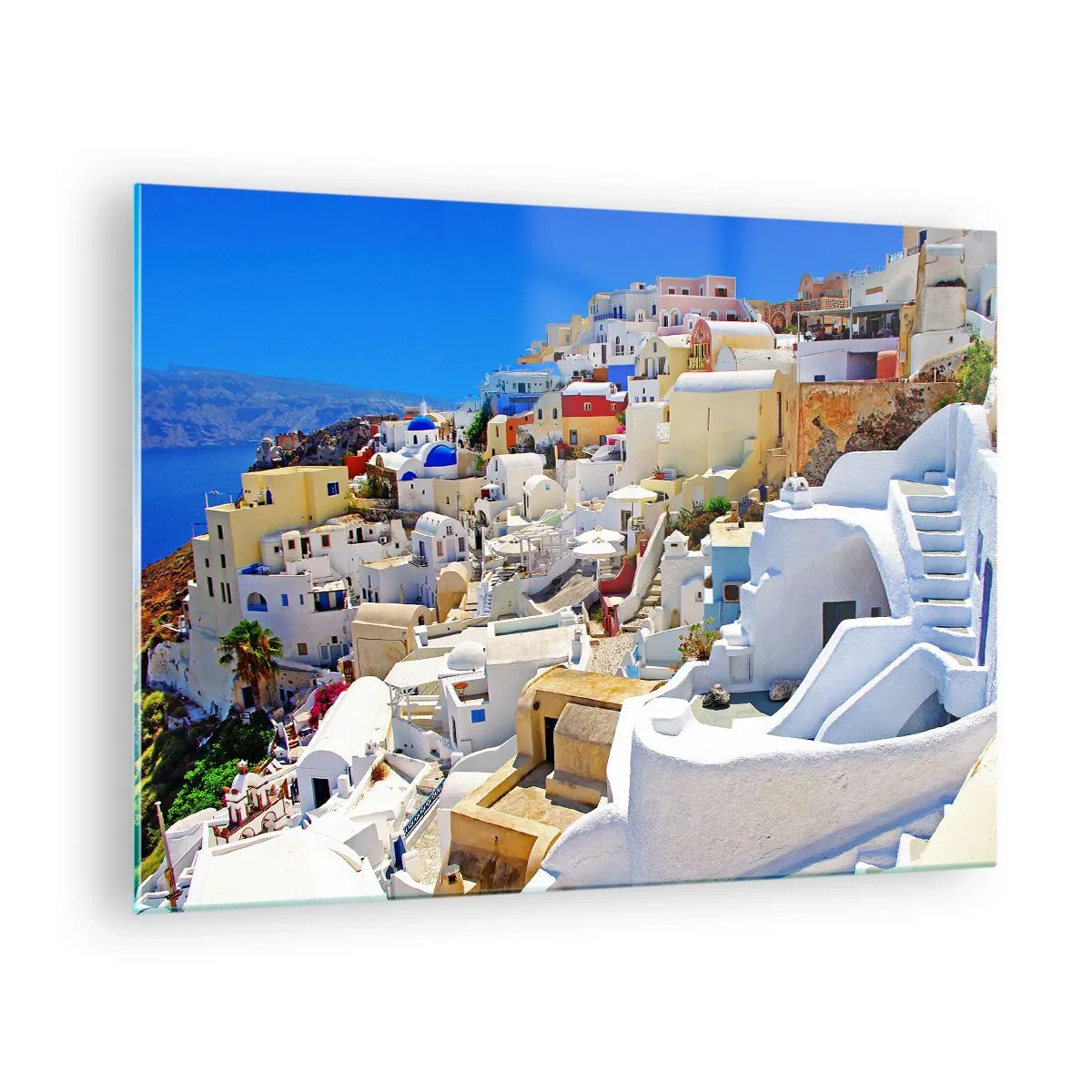 Obraz na szkle - Santorini z białymi domami na tle błękitnego nieba - 70x50cm - Marzenie o greckim lecie - Nowoczesna dekoracja ścienna do salonu i sypialni ARTTOR