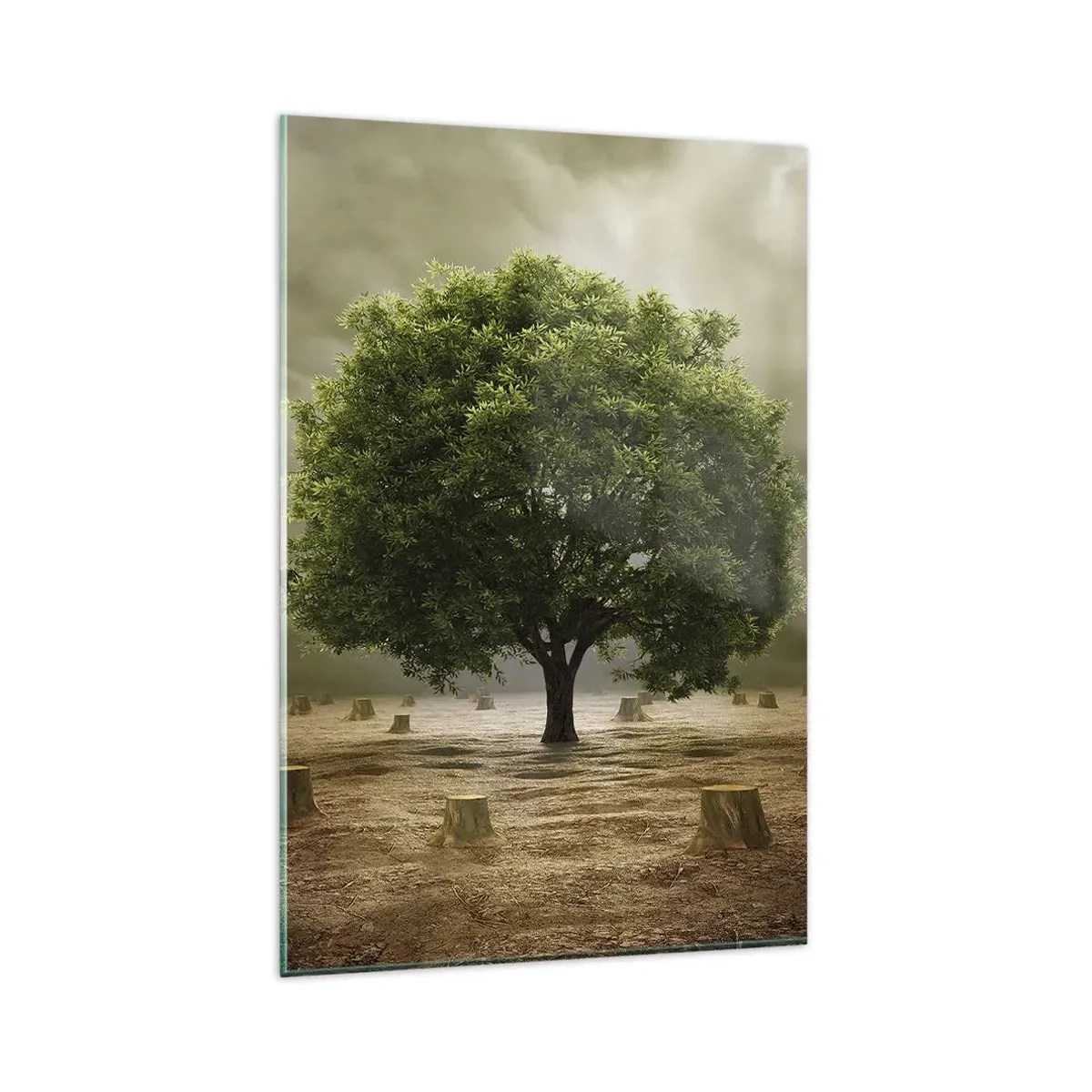 Obraz na szkle - Zielone drzewo otoczone pniami ściętych drzew na tle pochmurnego nieba - 80x120cm - Cała nadzieja - Nowoczesna dekoracja ścienna do salonu i sypialni ARTTOR