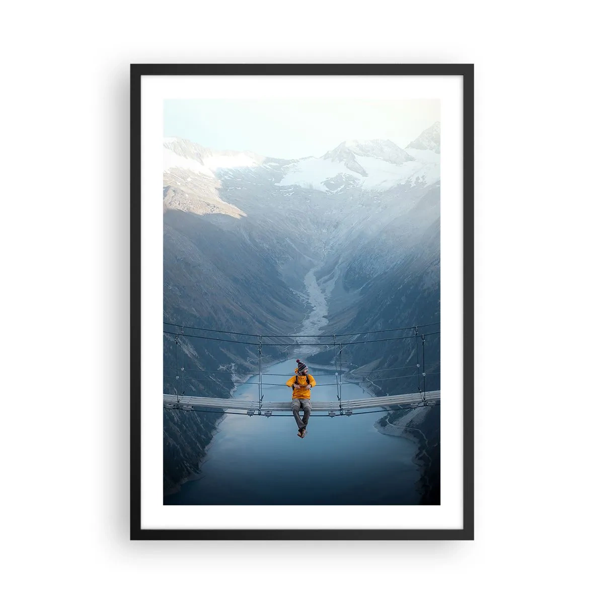 Plakat w czarnej ramie - Osoba w żółtej kurtce siedząca na wiszącym moście nad doliną - 50x70cm - Zachwycony w zawieszeniu - Nowoczesna dekoracja ścienna do salonu i sypialni ARTTOR