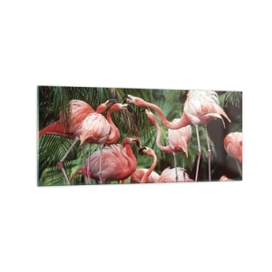 Obraz na szkle - Grupa flamingów w tropikalnym otoczeniu palm - 120x50cm - Popołudniowe ploteczki - Nowoczesna dekoracja ścienna do salonu i sypialni ARTTOR
