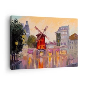 Obraz na płótnie - Czerwony wiatrak Moulin Rouge otoczony miejskim pejzażem - 70x50cm - Paryskie ikony – Moulin Rouge - Nowoczesna dekoracja ścienna do salonu i sypialni ARTTOR