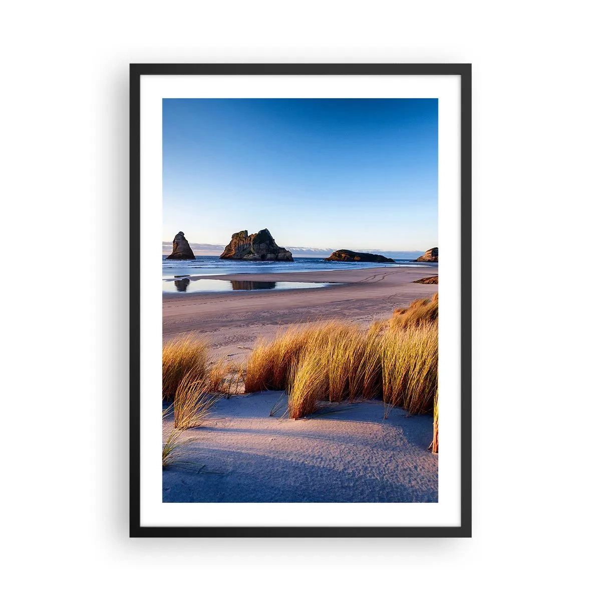 Plakat w czarnej ramie - Malownicza plaża z trawami i skałami na tle spokojnego oceanu - 50x70cm - Dla poszukiwaczy spokoju - Nowoczesna dekoracja ścienna do salonu i sypialni ARTTOR