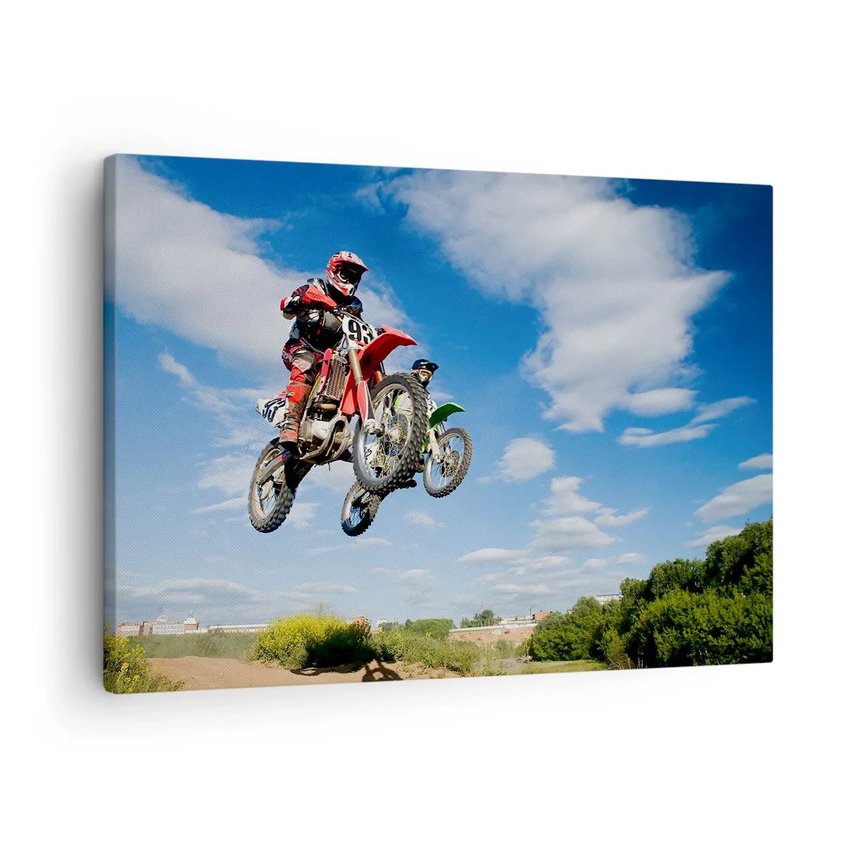 Obraz na płótnie - Zawodnicy na motocyklach crossowych w powietrzu podczas skoku - 70x50cm - Podniebny skok - Nowoczesna dekoracja ścienna do salonu i sypialni ARTTOR
