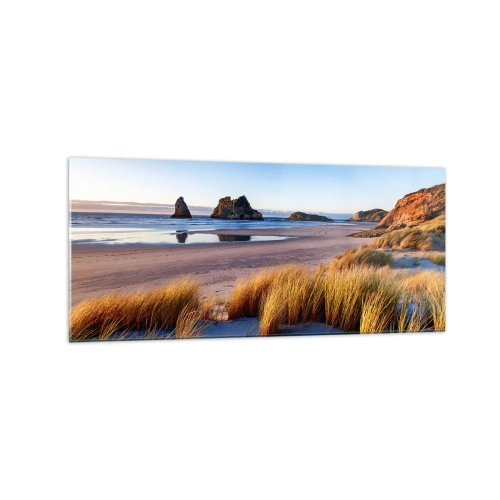 Obraz na szkle - Malownicza plaża z widokiem na skały i morze o zachodzie słońca - 120x50cm - Dla poszukiwaczy spokoju - Nowoczesna dekoracja ścienna do salonu i sypialni ARTTOR