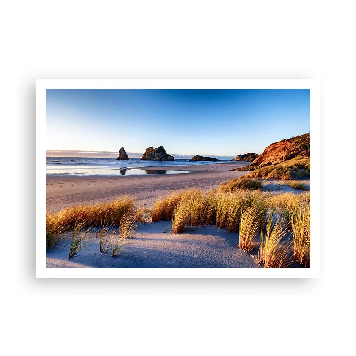 Plakat - Malownicza plaża z widokiem na skały i morze o zachodzie słońca - 100x70cm - Dla poszukiwaczy spokoju - Nowoczesna dekoracja ścienna do salonu i sypialni ARTTOR