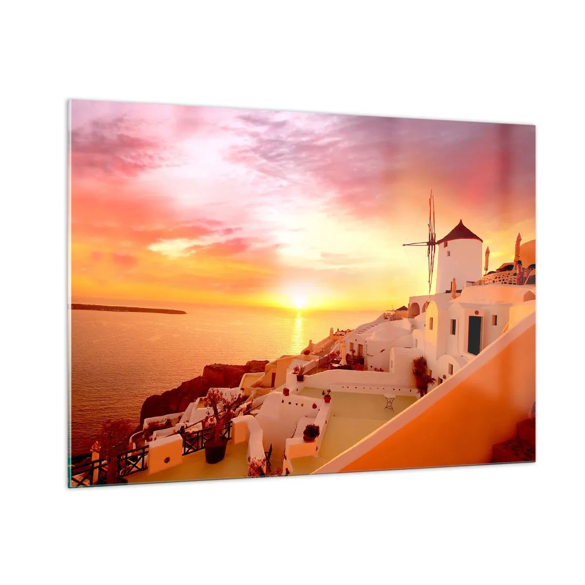 Obraz na szkle - Zachód słońca nad Santorini z białymi budynkami i wiatrakiem - 100x70cm - Rozpłynąć się w bieli i złocie - Nowoczesna dekoracja ścienna do salonu, kuchni i sypialni ARTTOR