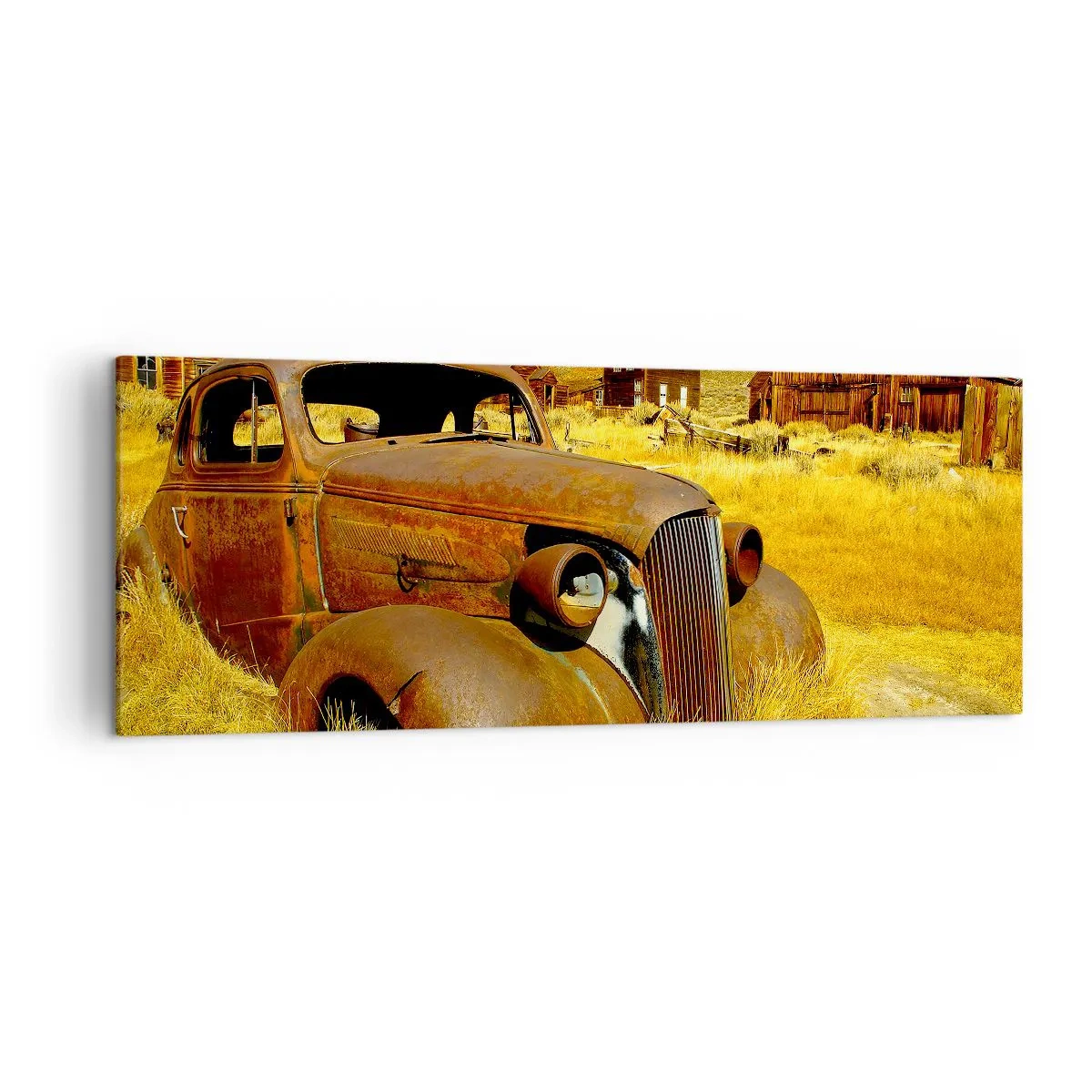 Obraz na płótnie - Stary zardzewiały samochód na tle opuszczonych drewnianych chat - 140x50cm - Zasłużony odpoczynek - Nowoczesna dekoracja ścienna do salonu i sypialni ARTTOR