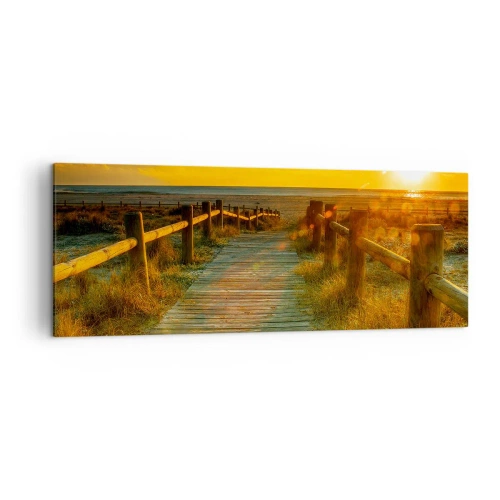 Obraz na płótnie - Drewniana ścieżka prowadząca na plażę w blasku zachodzącego słońca - 140x50cm - Skąpane w starym złocie - Nowoczesna dekoracja ścienna do salonu i sypialni ARTTOR