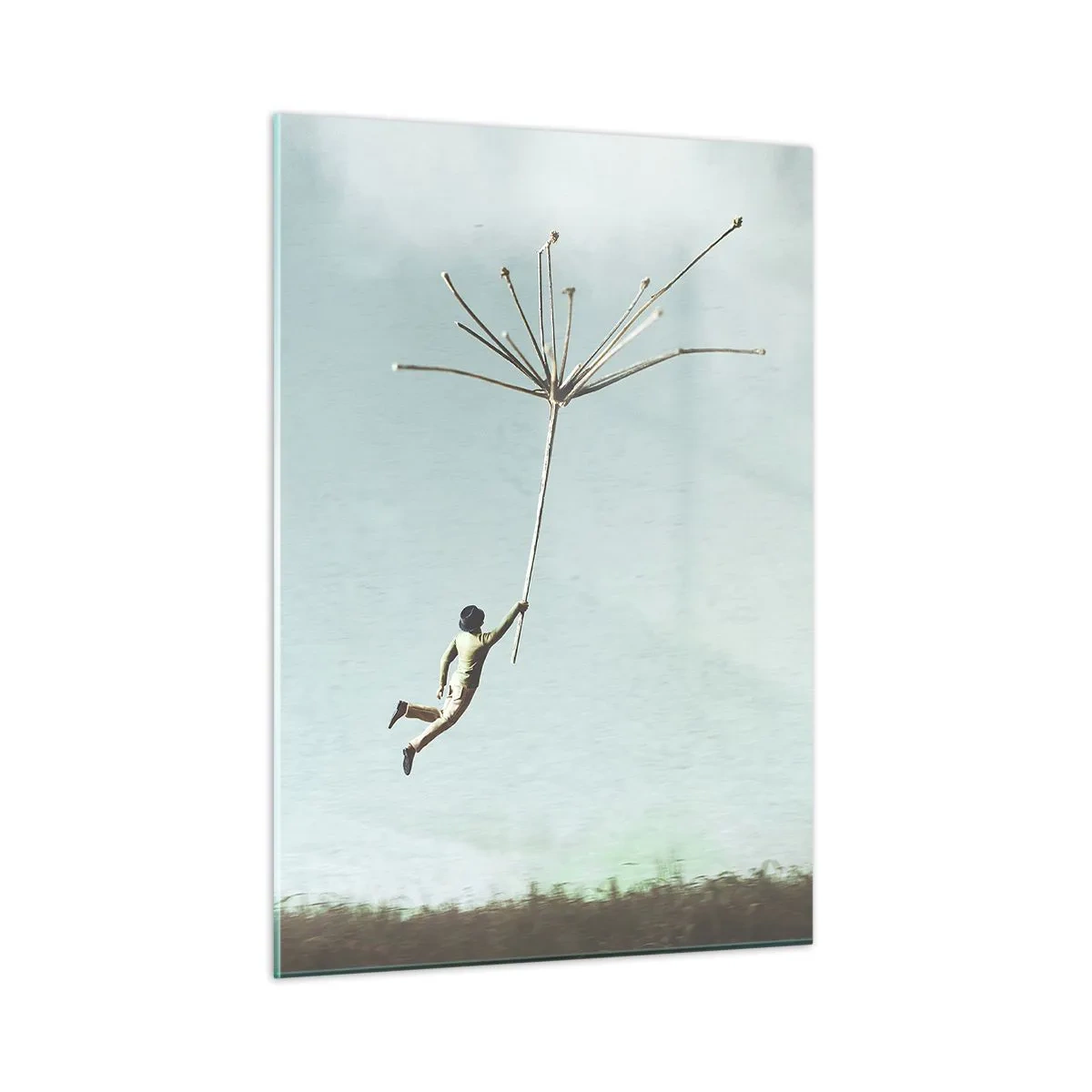 Obraz na szkle - Chłopiec lecący z nasionem dmuchawca nad łąką - 50x70cm - Latawce, dmuchawce, wiatr - Nowoczesna dekoracja ścienna do salonu, kuchni i sypialni ARTTOR