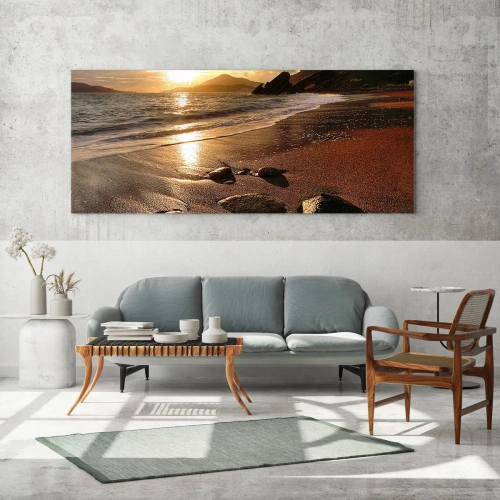 Obraz na szkle - Plaża o zachodzie słońca z kamieniami na brzegu - 120x50cm - Idź za słońcem ku wzgórzom - Nowoczesna dekoracja ścienna do salonu i sypialni ARTTOR