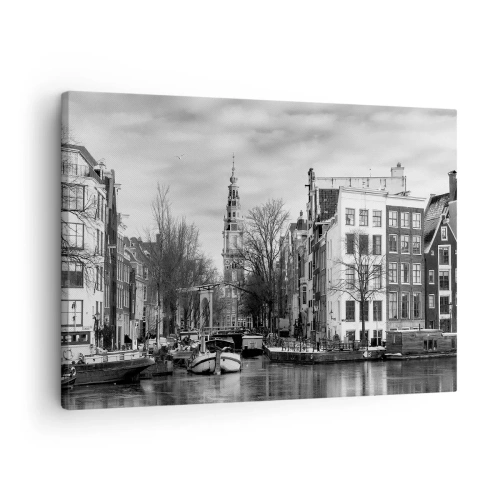 Obraz na płótnie - Czarno-biała panorama Amsterdamu z kanałem i zabytkowymi budynkami - 70x50cm - Amsterdamskie klimaty - Nowoczesna dekoracja ścienna do salonu i sypialni ARTTOR
