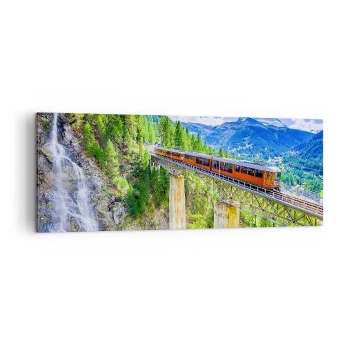 Obraz na płótnie - Górska kolejka na moście z widokiem na wodospad i góry - 140x50cm - Kolej na Alpy - Nowoczesna dekoracja ścienna do salonu i sypialni ARTTOR
