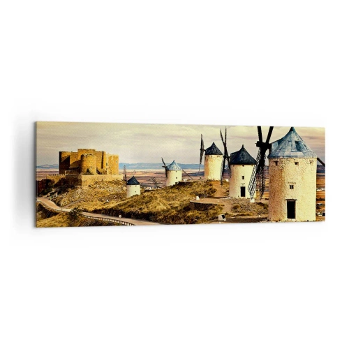 Obraz na płótnie - Wiatraki na wzgórzach z historycznym zamkiem w tle - 160x50cm - Zaraz pojawi się Don Kichot - Nowoczesna dekoracja ścienna do salonu i sypialni ARTTOR