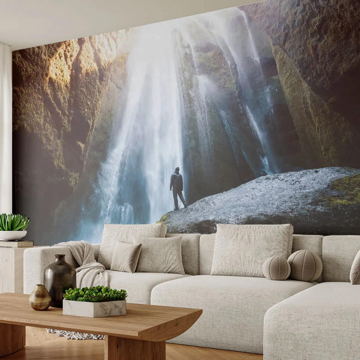 Fototapeta Premium Sand - Wodospad wśród gór z sylwetką człowieka na skale - 100x70cm - Przywrócenie proporcji - Nowoczesna dekoracja ścienna do salonu, kuchni i sypialni ARTTOR
