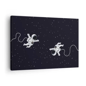 Obraz na płótnie - Astronauci unoszący się w kosmosie na tle gwiazd - 70x50cm - Kosmiczny pląs - Nowoczesna dekoracja ścienna do salonu i sypialni ARTTOR