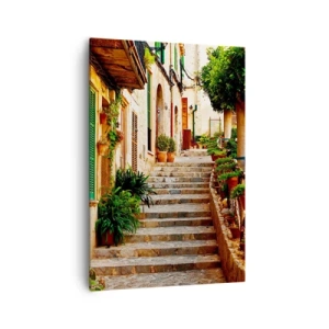 Obraz na płótnie - Malownicza, kamienna uliczka z roślinami i schodami w hiszpańskim miasteczku - 70x100cm - Czar hiszpańskich wakacji - Nowoczesna dekoracja ścienna do salonu i sypialni ARTTOR