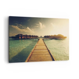 Obraz na płótnie - Drewniany pomost prowadzący do domków na wodzie oświetlonych promieniami słońca - 100x70cm - Gorące zaproszenie - Nowoczesna dekoracja ścienna do salonu, kuchni i sypialni ARTTOR