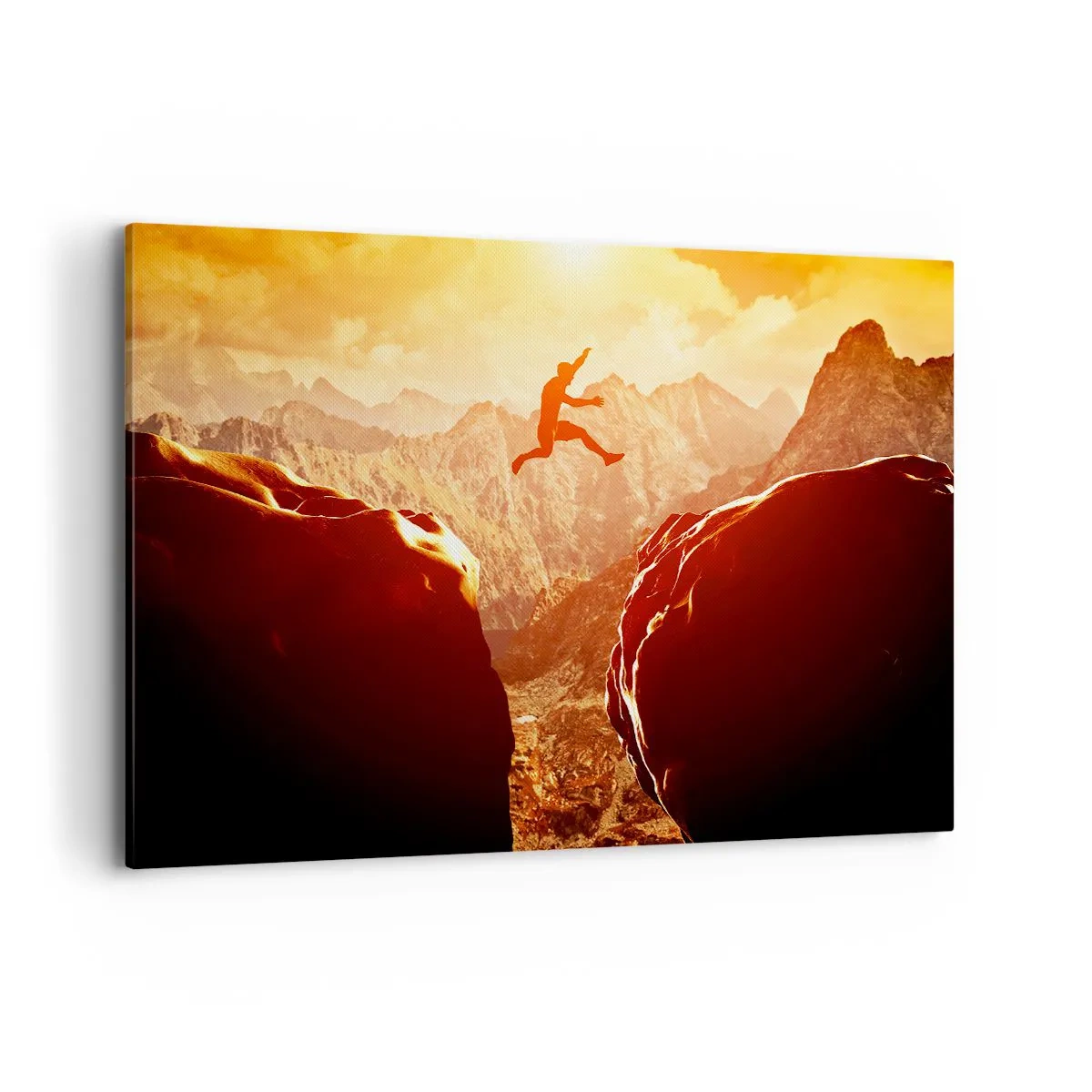 Obraz na płótnie - Postać skacząca między skałami na tle gór - 120x80cm - Przekraczając granice - Nowoczesna dekoracja ścienna do salonu, kuchni i sypialni ARTTOR