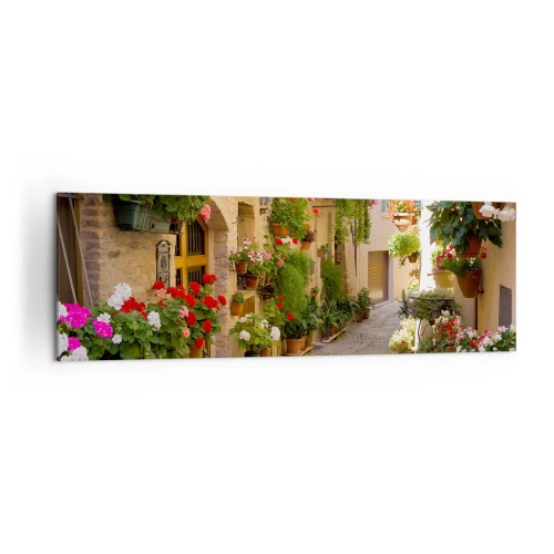 Obraz na płótnie - Uliczka z kwiatami w donicach i kamiennymi ścianami - 160x50cm - W kwiatów powodzi - Nowoczesna dekoracja ścienna do salonu i sypialni ARTTOR