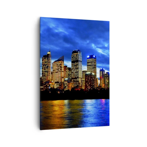 Obraz na płótnie - Panorama nocnego miasta z podświetlonymi wieżowcami nad wodą - 70x100cm - Noc świateł i barw - Nowoczesna dekoracja ścienna do salonu i sypialni ARTTOR