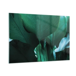 Obraz na szkle - Tropikalne liście w intensywnych odcieniach zieleni - 100x70cm - Zwrócone do światła - Nowoczesna dekoracja ścienna do salonu, kuchni i sypialni ARTTOR