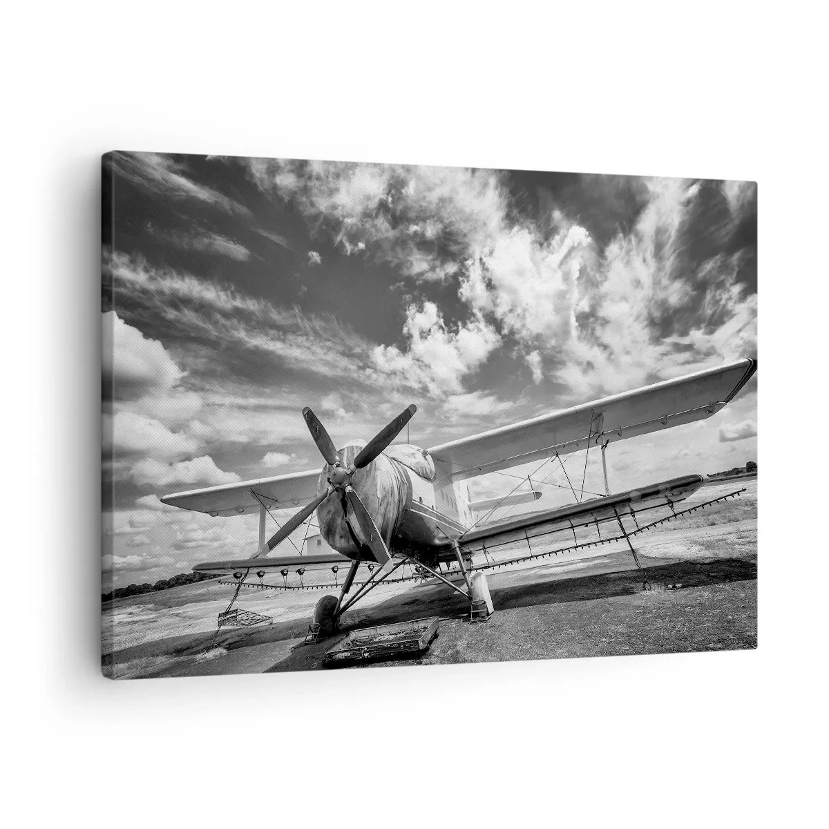 Obraz na płótnie - Stary samolot na lotnisku w czarno-białym ujęciu - 70x50cm - Nie mogę się doczekać! - Nowoczesna dekoracja ścienna do salonu i sypialni ARTTOR