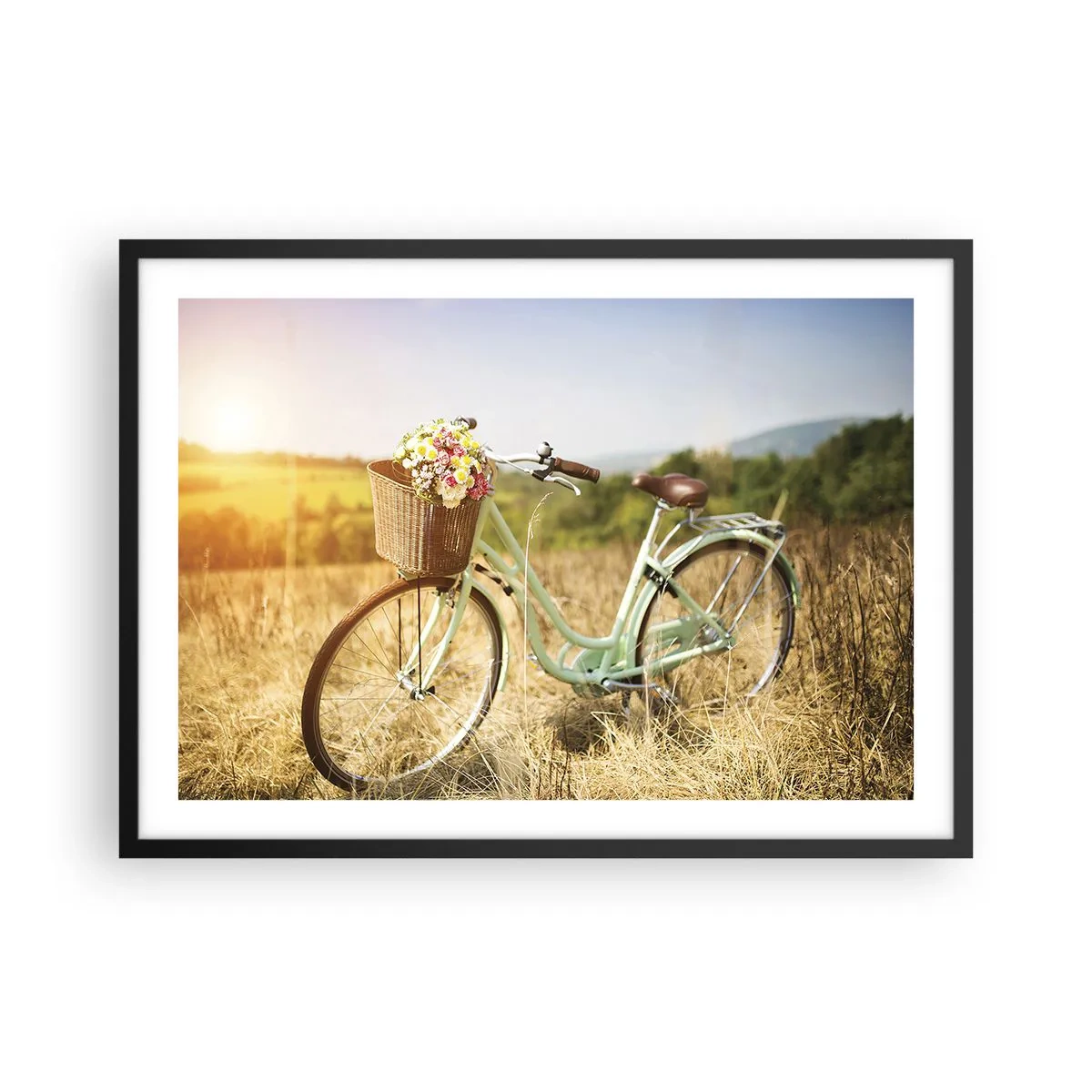 Plakat w czarnej ramie - Retro rower z koszykiem pełnym kwiatów na tle łąki - 70x50cm - Zostanę tu chwilę - Nowoczesna dekoracja ścienna do salonu i sypialni ARTTOR