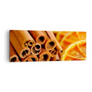 Obraz na płótnie - Laski cynamonu z suszonymi plastrami pomarańczy w ciepłych barwach - 140x50cm - Czujesz ich aromat? - Nowoczesna dekoracja ścienna do salonu i sypialni ARTTOR
