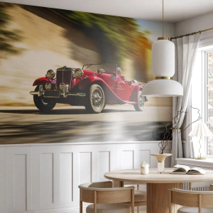 Fototapeta Standard Eco - Czerwony klasyczny kabriolet w dynamicznym ruchu - 100x70cm - Piękniejszy niż Nike z Samotraki - Nowoczesna dekoracja ścienna do salonu i sypialni ARTTOR