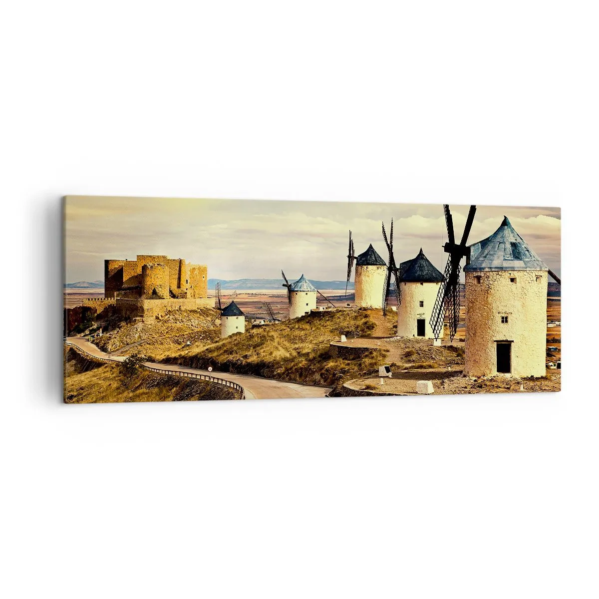 Obraz na płótnie - Wiatraki na wzgórzach z historycznym zamkiem w tle - 140x50cm - Zaraz pojawi się Don Kichot - Nowoczesna dekoracja ścienna do salonu i sypialni ARTTOR