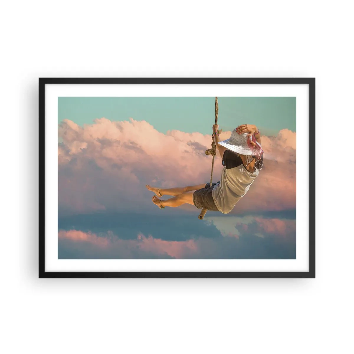 Plakat w czarnej ramie - Kobieta na huśtawce wśród różowych chmur - 70x50cm - Zabawa w obłokach - Nowoczesna dekoracja ścienna do salonu i sypialni ARTTOR