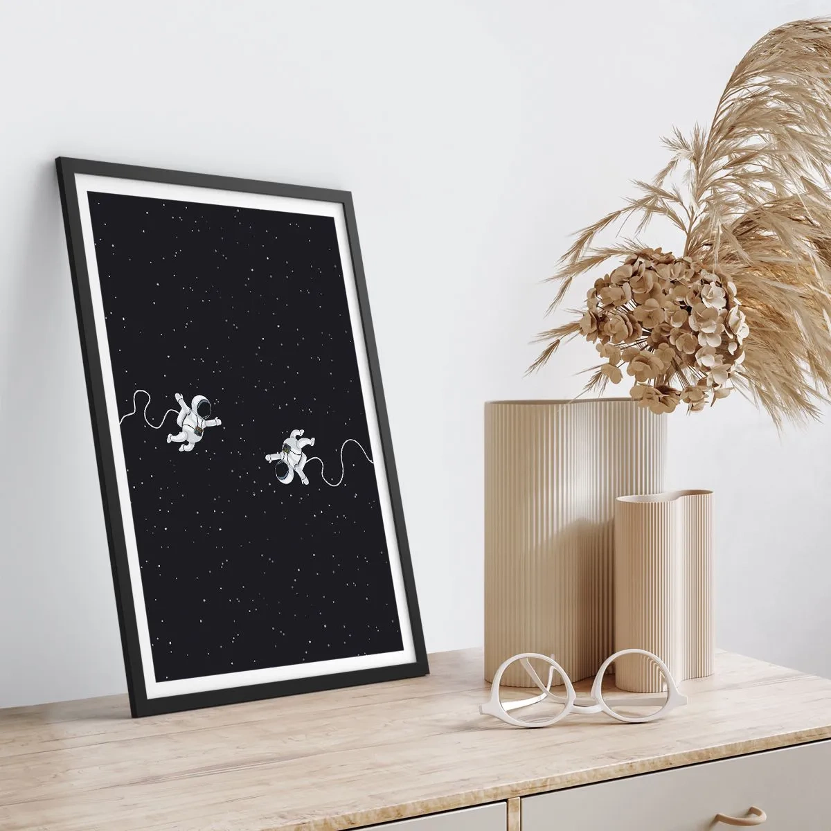 Plakat w czarnej ramie - Dwóch astronautów unoszących się w przestrzeni kosmicznej - 50x70cm - Kosmiczny pląs - Nowoczesna dekoracja ścienna do salonu i sypialni ARTTOR