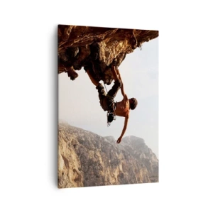 Obraz na płótnie - Wspinacz na stromym klifie w górach w promieniach słońca - 70x100cm - Świat skurczony w garści na obrywie głazu - Nowoczesna dekoracja ścienna do salonu i sypialni ARTTOR
