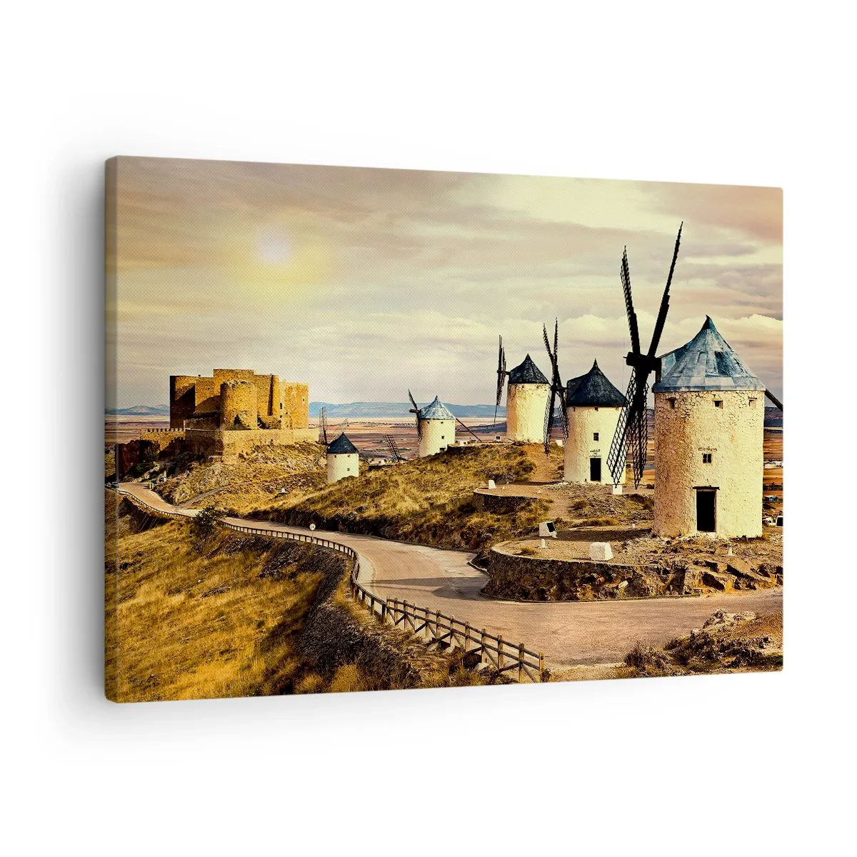 Obraz na płótnie - Wiatraki na wzgórzach z historycznym zamkiem w tle - 70x50cm - Zaraz pojawi się Don Kichot - Nowoczesna dekoracja ścienna do salonu i sypialni ARTTOR