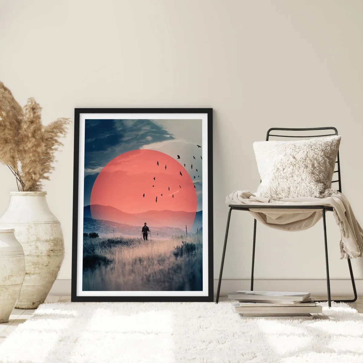 Plakat w czarnej ramie - W swoich żywiołach - Mężczyzna idący przez pole na tle czerwonego słońca - 50x70cm