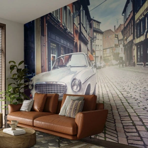 Fototapeta Premium Sand - Klasyczny samochód na brukowanej ulicy w historycznym mieście - 100x70cm - Przeszłość to dziś - Nowoczesna dekoracja ścienna do salonu, kuchni i sypialni ARTTOR
